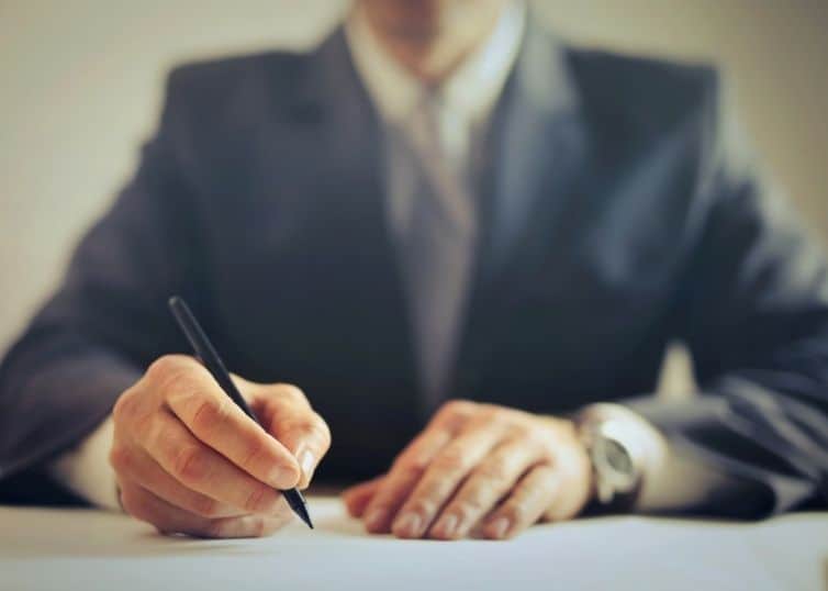 Lawyer sitting at desk filling out paperwork
