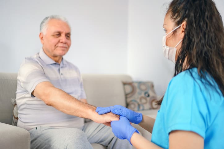 holding patient's hand for support in trauma-based care