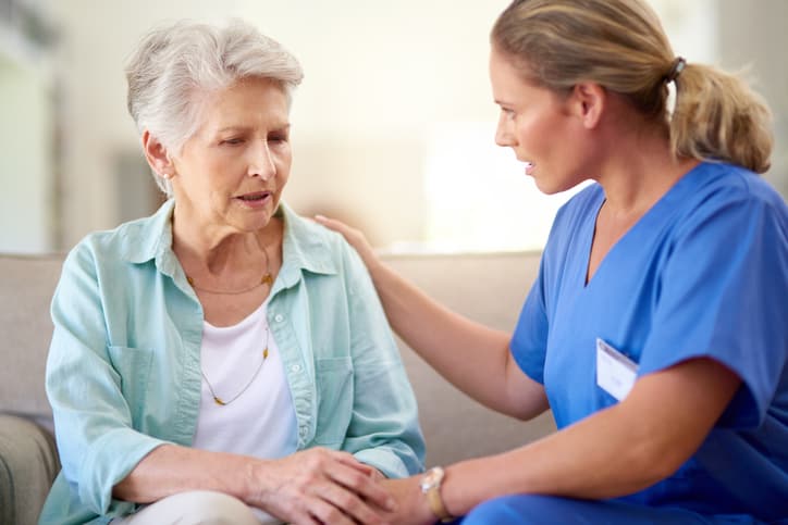 SANE nurse consoling a senior patient in a nursing home
