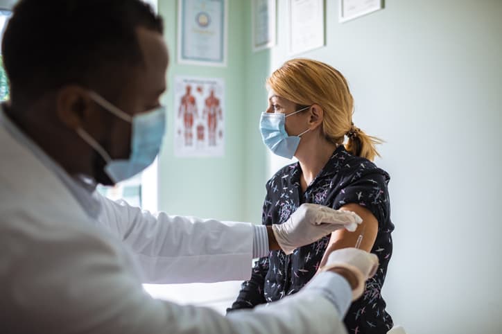 Close up of a young woman getting vaccinated