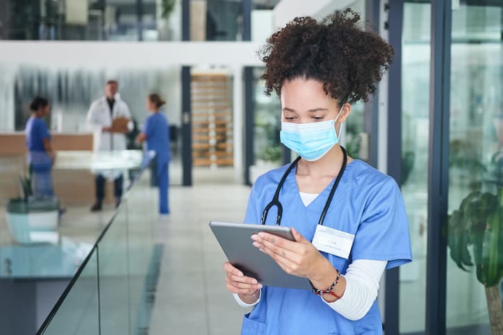 Young nurse using a digital tablet to access professional development resources for nurses