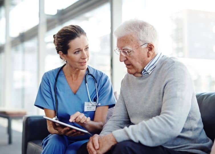 Nurse assessing cognitive decline in older adult male patient