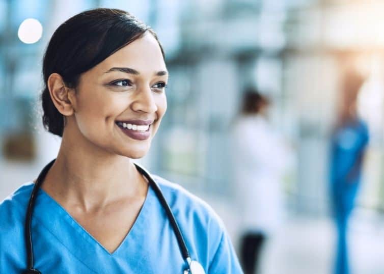 Close up of smiling female nurse in medical building