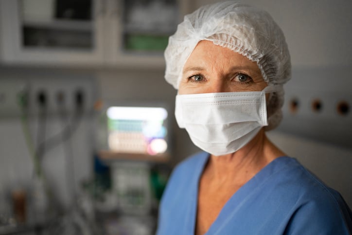 Portrait of female healthcare worker with face mask in operating room at hospital