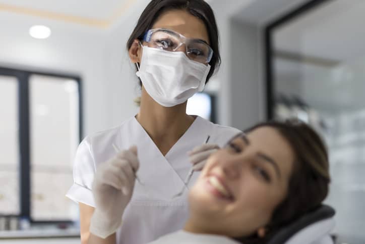 Female dental hygienist and patient in dental clinic