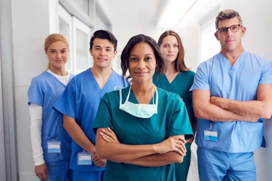 Diverse group of young nurses in hospital hallway, nursing career pathways concept