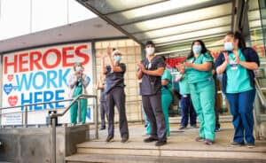 Manhattan, New York, USA - May 21, 2020: Healthcare workers at the Lenox Health Emergency room entrance are greeted to cheers and thanks for their essential service during the covid-19 pandemic in New York City.