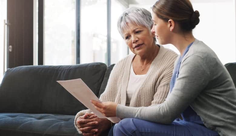Nurse improving health literacy by helping senior woman make informed decisions about her health