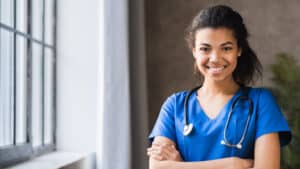 Portrait of young nurse in uniform smiling confidently, leadership skills program for new nurses concept